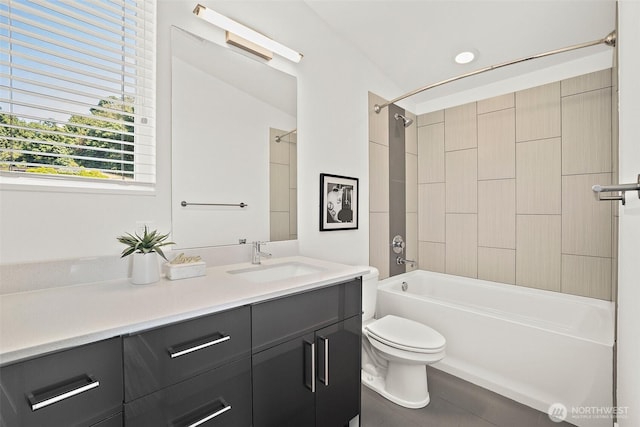 bathroom with toilet, vanity, and washtub / shower combination