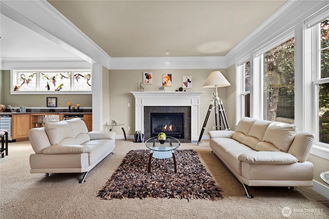 living room with a wealth of natural light, a fireplace with flush hearth, crown molding, and light colored carpet