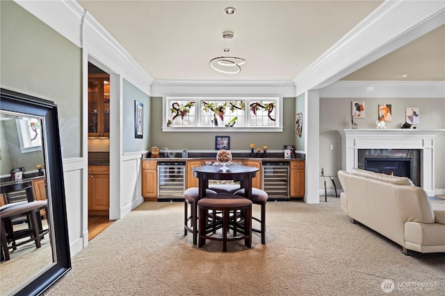 dining area featuring wine cooler, wet bar, and ornamental molding