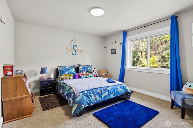 bedroom featuring carpet and baseboards