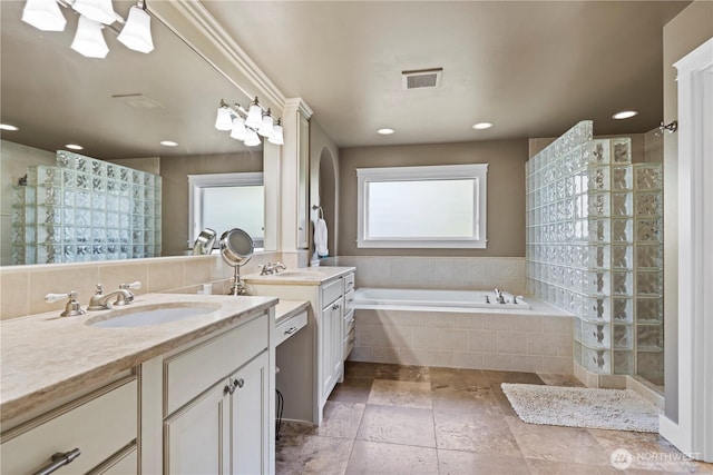 bathroom featuring visible vents, a walk in shower, and a sink