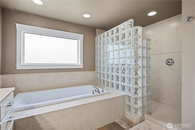 full bath featuring walk in shower, a garden tub, and recessed lighting