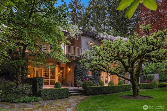 107 NW Highland Dr, Seattle, WA 98177 - obstructed view of property featuring a balcony, stucco siding, and a front lawn
