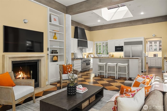 107 NW Highland Dr, Seattle, WA 98177 - living area featuring a skylight, a warm lit fireplace, and recessed lighting