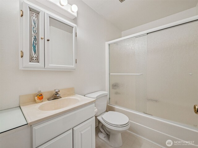 full bath featuring vanity, toilet, and combined bath / shower with glass door