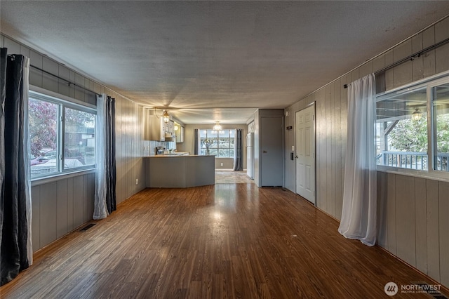 211 Pace Dr Unit 16, East Wenatchee, WA 98802 - unfurnished living room featuring wood finished floors and wooden walls