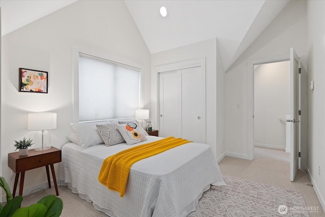 bedroom featuring a closet, light colored carpet, baseboards, and high vaulted ceiling