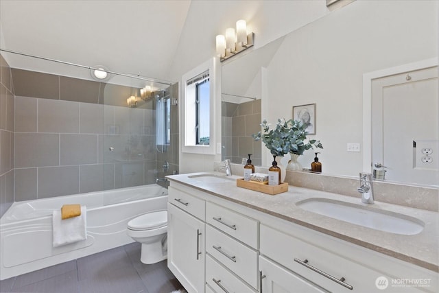 full bath with lofted ceiling, toilet, double vanity, tile patterned floors, and washtub / shower combination