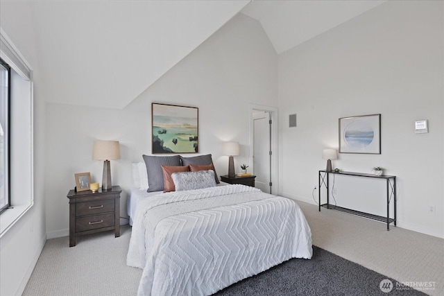 bedroom featuring light colored carpet, high vaulted ceiling, and baseboards