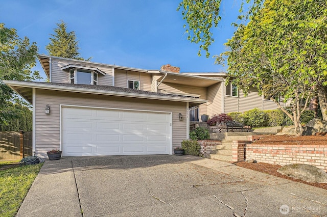 1851 58th St NE, Tacoma, WA 98422 - view of front of house with concrete driveway, a chimney, and a garage