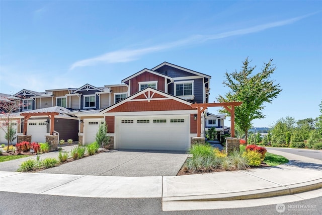 craftsman-style house featuring stone siding, driveway, and an attached garage