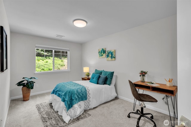 carpeted bedroom featuring baseboards and an office area