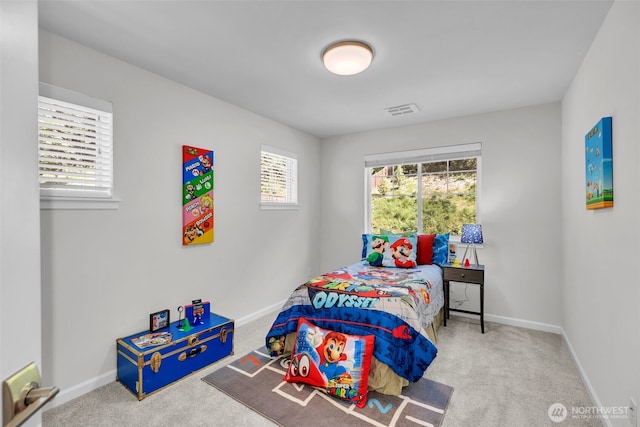 bedroom with multiple windows, carpet flooring, and baseboards