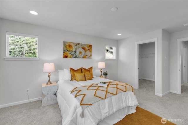 bedroom featuring carpet flooring, baseboards, a walk in closet, recessed lighting, and a closet