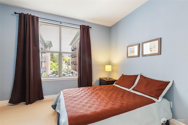 bedroom featuring carpet flooring and baseboards