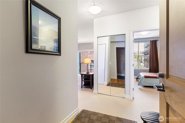 hallway featuring baseboards