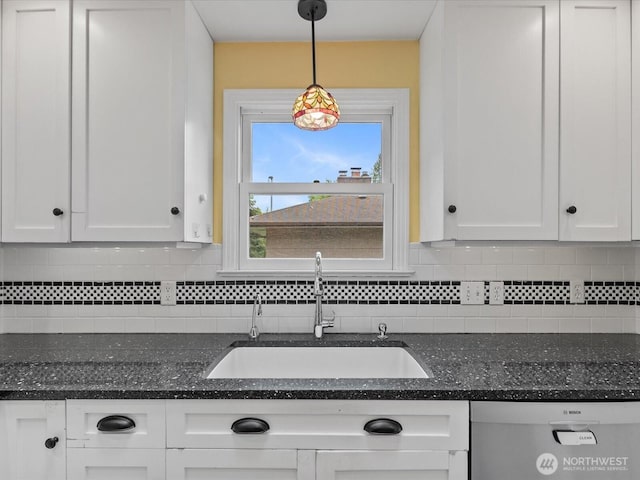 kitchen featuring a sink, dishwasher, white cabinets, and backsplash