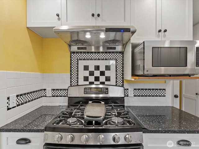 kitchen with stainless steel appliances, island range hood, white cabinets, and decorative backsplash