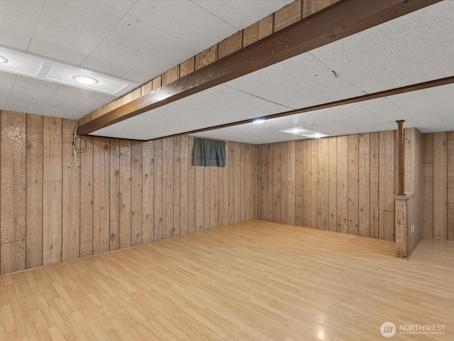 finished below grade area with wood finished floors and wood walls