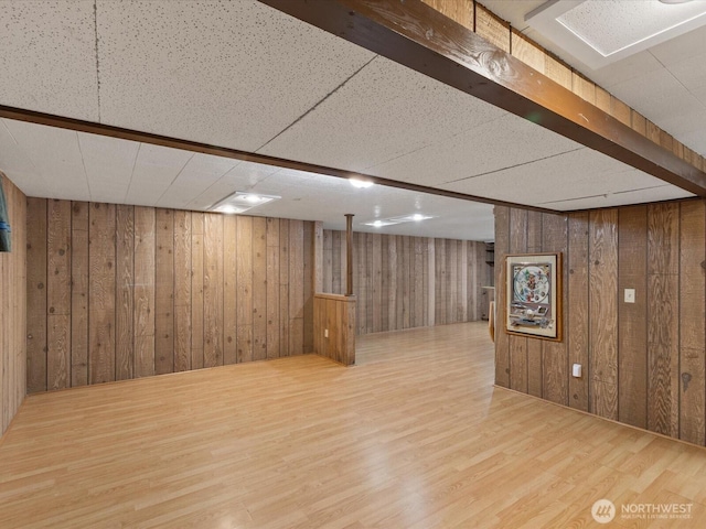finished below grade area with wood finished floors and wooden walls