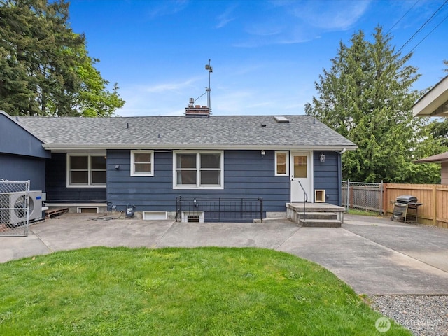 rear view of property featuring a cooling unit, a patio area, roof with shingles, and a chimney