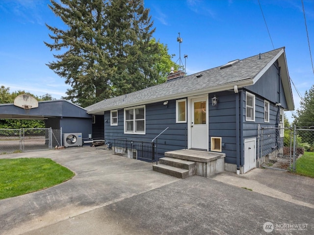 view of front of home featuring a gate, fence, a chimney, ac unit, and roof with shingles