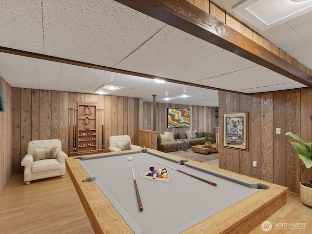 game room with pool table, wooden walls, and light wood-style floors