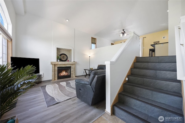 2983 Sonoran Dr, Richland, WA 99354 - staircase featuring a lit fireplace, a wealth of natural light, a ceiling fan, and wood finished floors