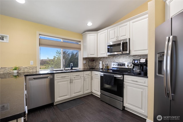 2983 Sonoran Dr, Richland, WA 99354 - kitchen featuring backsplash, dark countertops, appliances with stainless steel finishes, and a sink