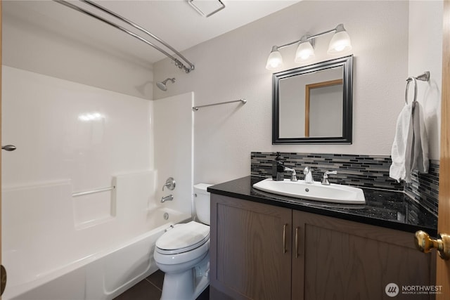 2983 Sonoran Dr, Richland, WA 99354 - full bathroom with shower / bathing tub combination, toilet, vanity, tile patterned flooring, and decorative backsplash