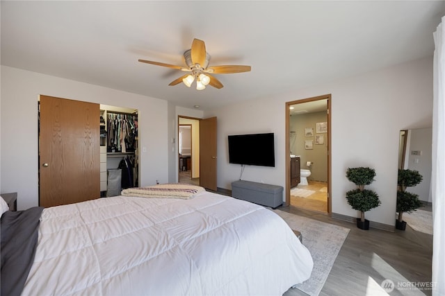2983 Sonoran Dr, Richland, WA 99354 - bedroom with connected bathroom, a ceiling fan, a closet, a walk in closet, and light wood-type flooring