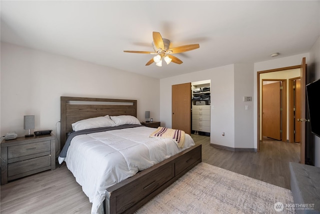 2983 Sonoran Dr, Richland, WA 99354 - bedroom featuring a ceiling fan, a closet, baseboards, light wood-style floors, and a spacious closet