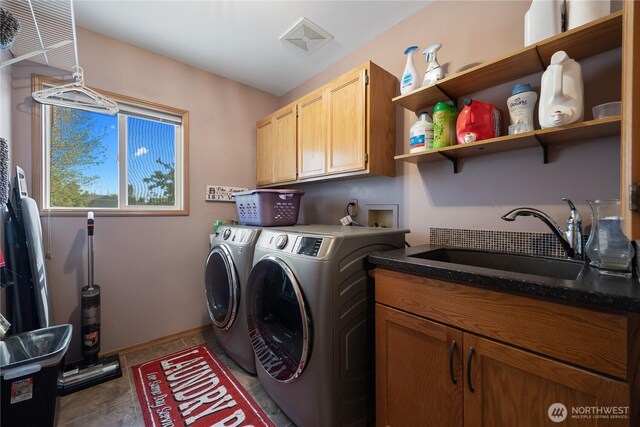 2983 Sonoran Dr, Richland, WA 99354 - laundry room with a sink, washer and clothes dryer, cabinet space, and baseboards