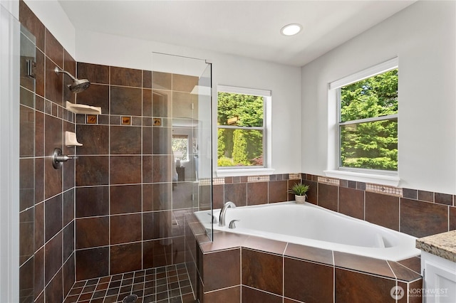 bathroom featuring a garden tub, a shower stall, and recessed lighting