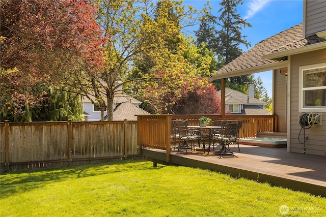 view of yard with a wooden deck and outdoor dining area