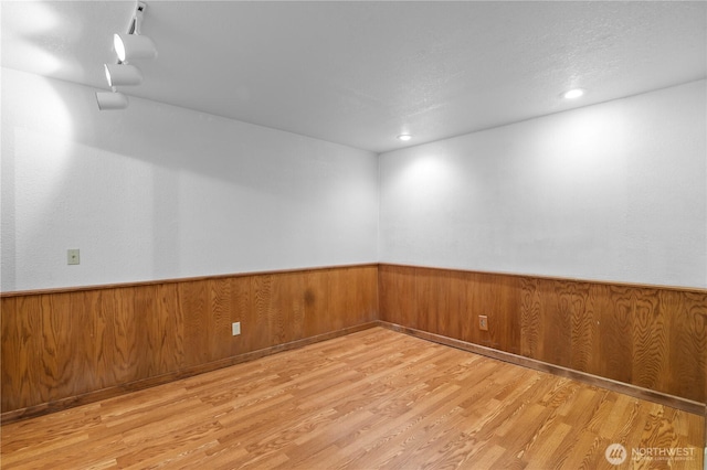 5127 215th St SE, Woodinville, WA 98072 - unfurnished room with wood finished floors, wainscoting, and wooden walls