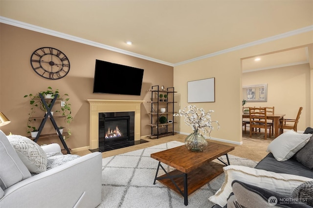 living area with crown molding, light carpet, baseboards, a fireplace with flush hearth, and recessed lighting