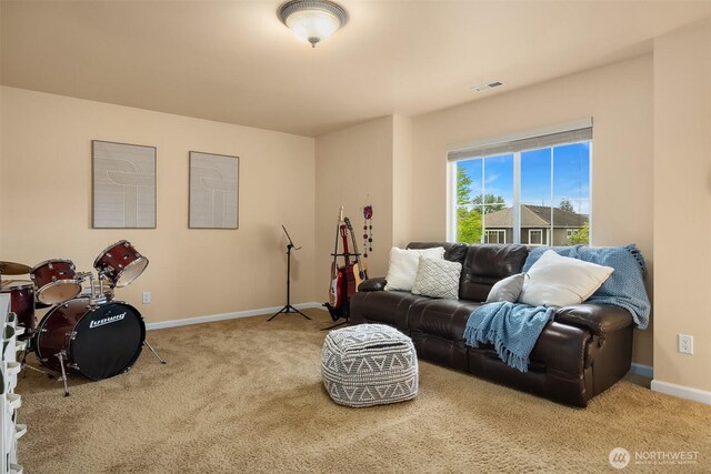 carpeted living room featuring baseboards