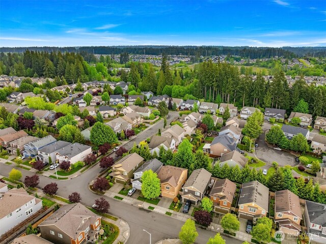 aerial perspective of suburban area with a heavily wooded area