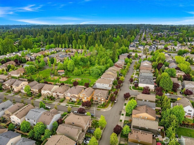 aerial view of residential area featuring a heavily wooded area