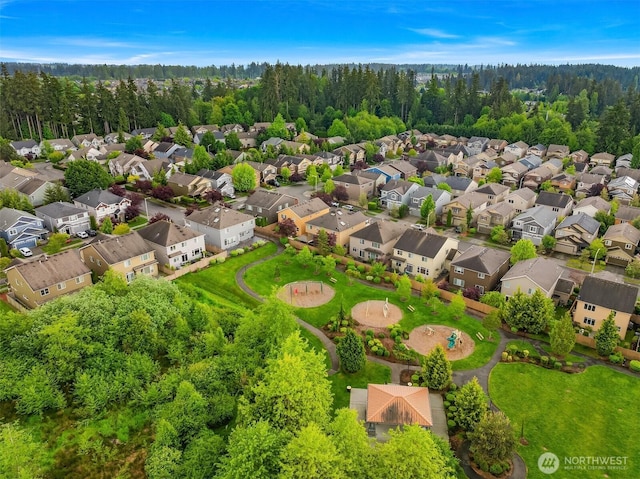 aerial view of residential area featuring a forest