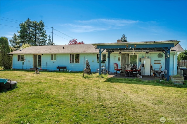 18246 Cinnamon Ln SW, Rochester, WA 98579 - back of property featuring a lawn, ceiling fan, a patio area, and a chimney
