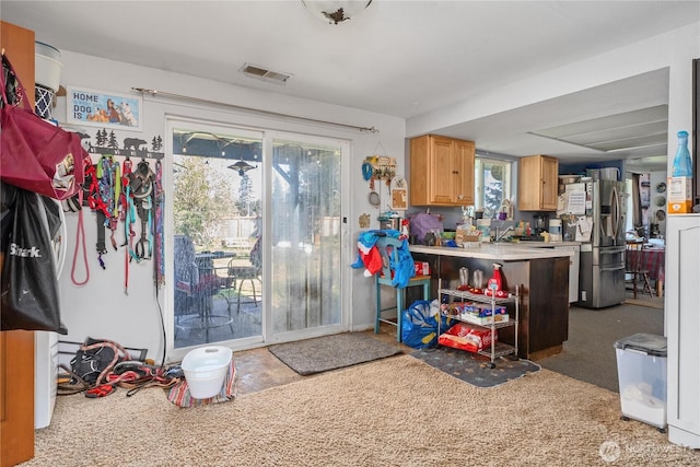 18246 Cinnamon Ln SW, Rochester, WA 98579 - kitchen with stainless steel fridge, light countertops, and a peninsula