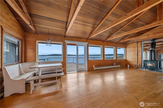 3312 SW 172nd St, Burien, WA 98166 - sunroom with a baseboard radiator, a wood stove, a water view, and a chandelier