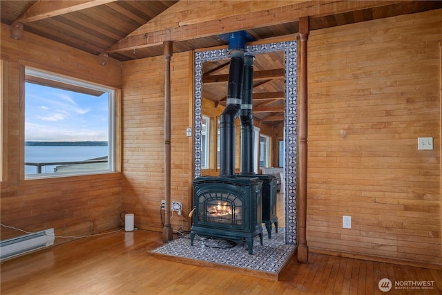 3312 SW 172nd St, Burien, WA 98166 - detailed view of a wood stove, wood walls, wooden ceiling, wood finished floors, and a baseboard radiator