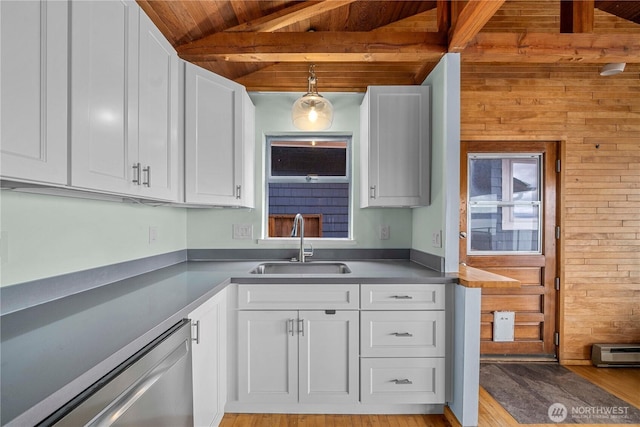 3312 SW 172nd St, Burien, WA 98166 - kitchen featuring a sink, stainless steel dishwasher, white cabinetry, wooden walls, and light wood-style floors