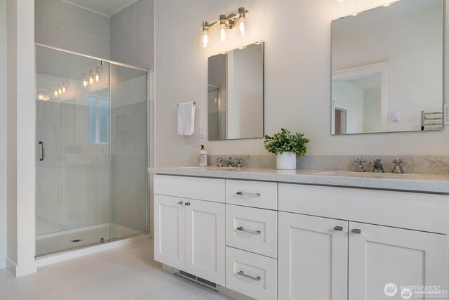 39195 Blackmouth Pl NE, Hansville, WA 98340 - full bathroom featuring double vanity, a stall shower, and tile patterned floors