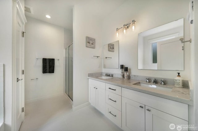 39195 Blackmouth Pl NE, Hansville, WA 98340 - full bathroom featuring double vanity, a stall shower, tile patterned floors, and recessed lighting