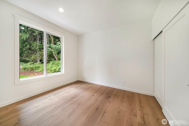 39195 Blackmouth Pl NE, Hansville, WA 98340 - empty room featuring healthy amount of natural light, baseboards, light wood-style floors, and recessed lighting