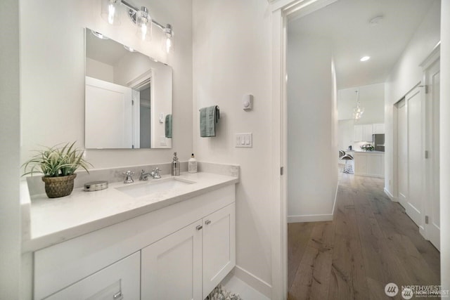 39195 Blackmouth Pl NE, Hansville, WA 98340 - bathroom with wood finished floors, vanity, and baseboards